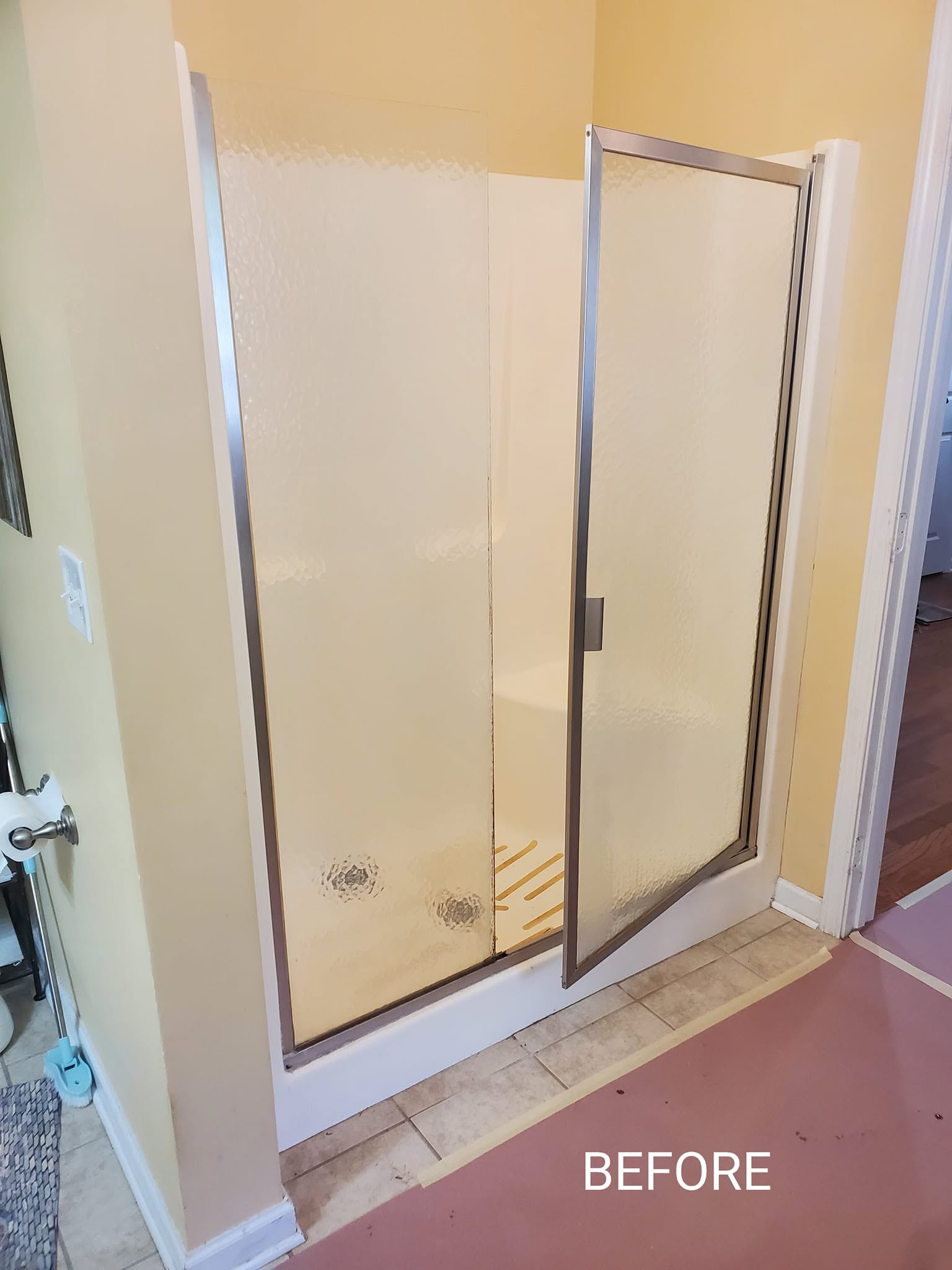 Old framed shower unit before demolition