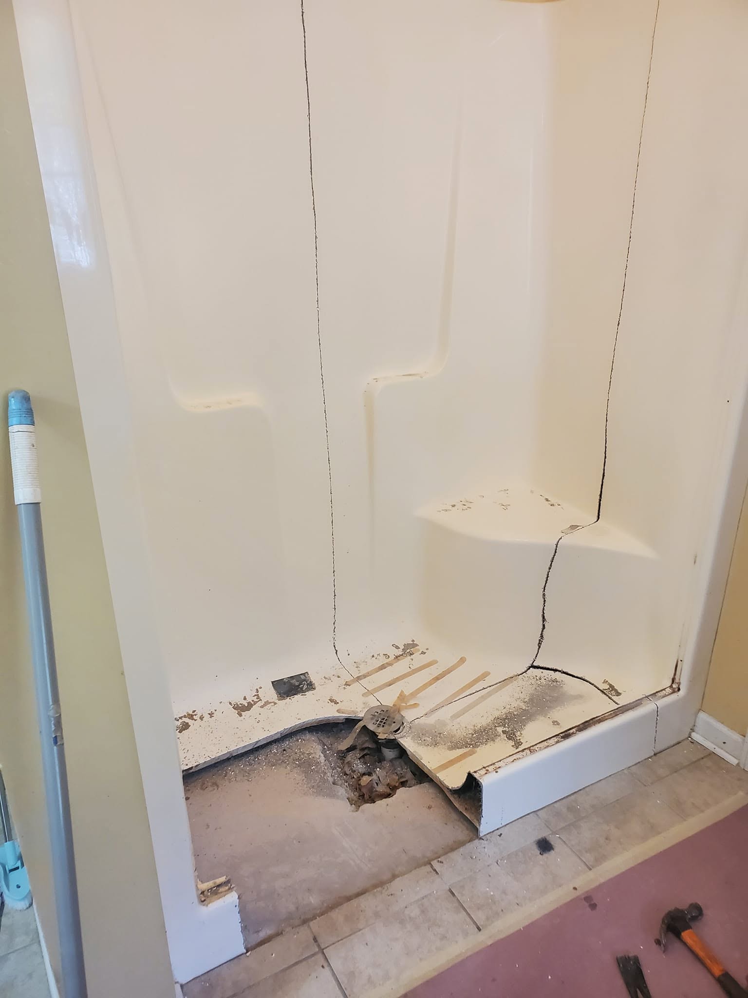 Tear-out: Cracked fiberglass unit removed, drain exposed